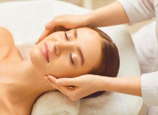 Face woman massage relax close up. Beautiful woman has a facial massage in a beauty clinic. Cosmetology skin care.